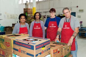 volunteers in red aprons